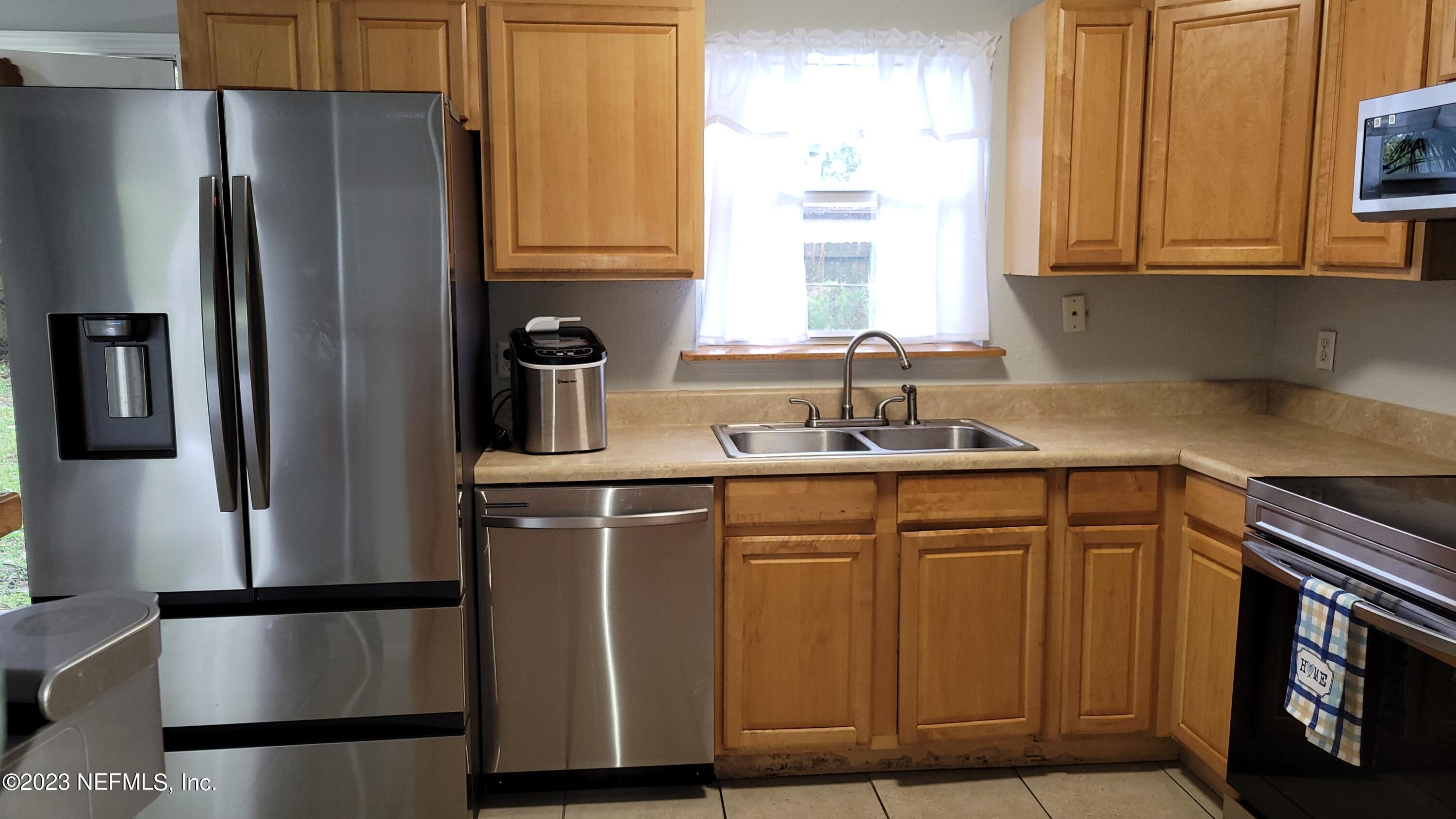 11685 Shellfish Drive Jacksonville, FL 32246 - Photo 6 of 32 a kitchen with stainless steel appliances granite countertop a refrigerator sink and cabinets