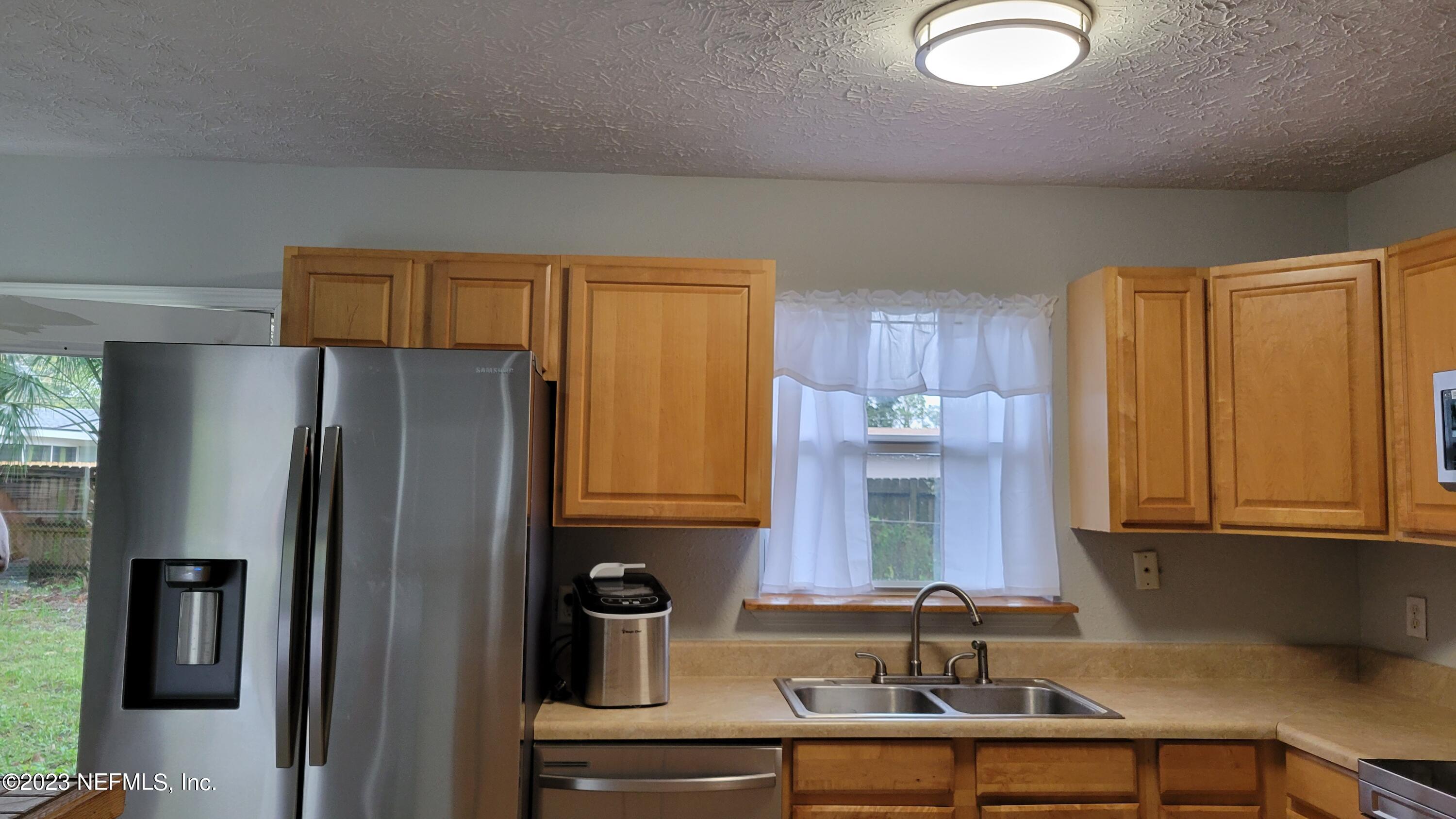 11685 Shellfish Drive Jacksonville, FL 32246 - Photo 7 of 32 a kitchen with stainless steel appliances granite countertop a refrigerator and a sink