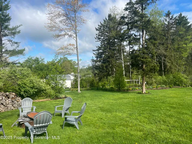 a view of a chair and table in the garden