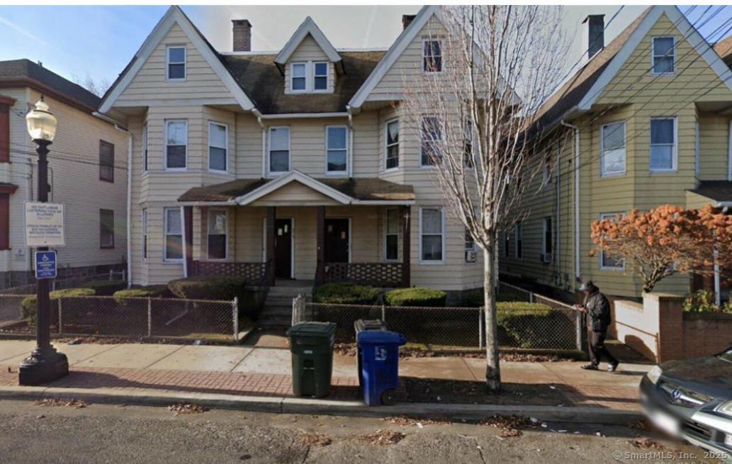 317 Madison Avenue, Unit 1 Bridgeport, CT 06604 - Photo 2 of 2 a front view of a house with garden