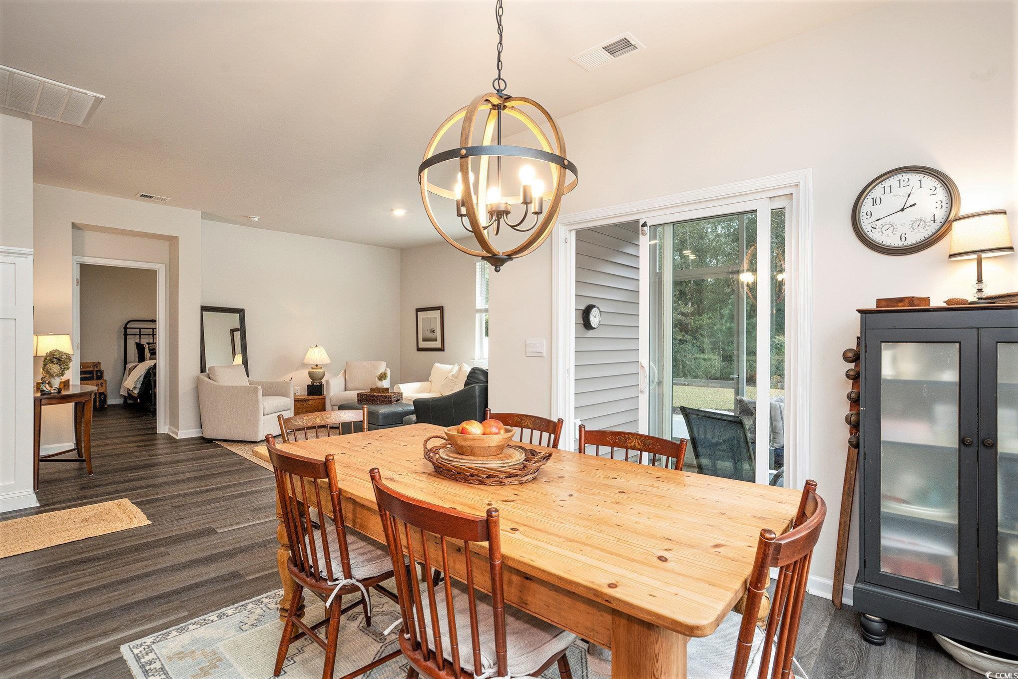 132 Columbus Street Conway, SC 29526 - Photo 11 of 39 Dining room featuring dark wood-style flooring and a chandelier
