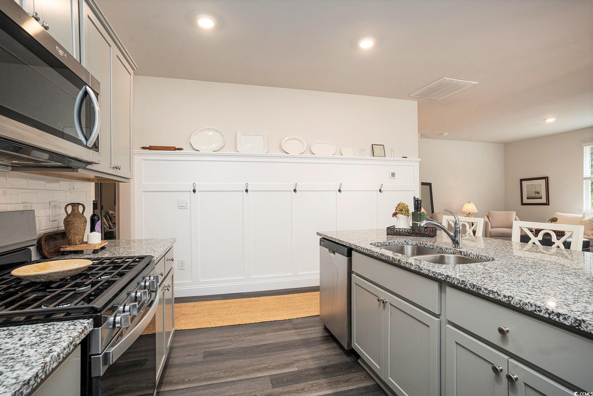 132 Columbus Street Conway, SC 29526 - Photo 13 of 39 Kitchen featuring gray cabinets, stainless steel appliances, light stone counters, recessed lighting, and dark wood-style floors