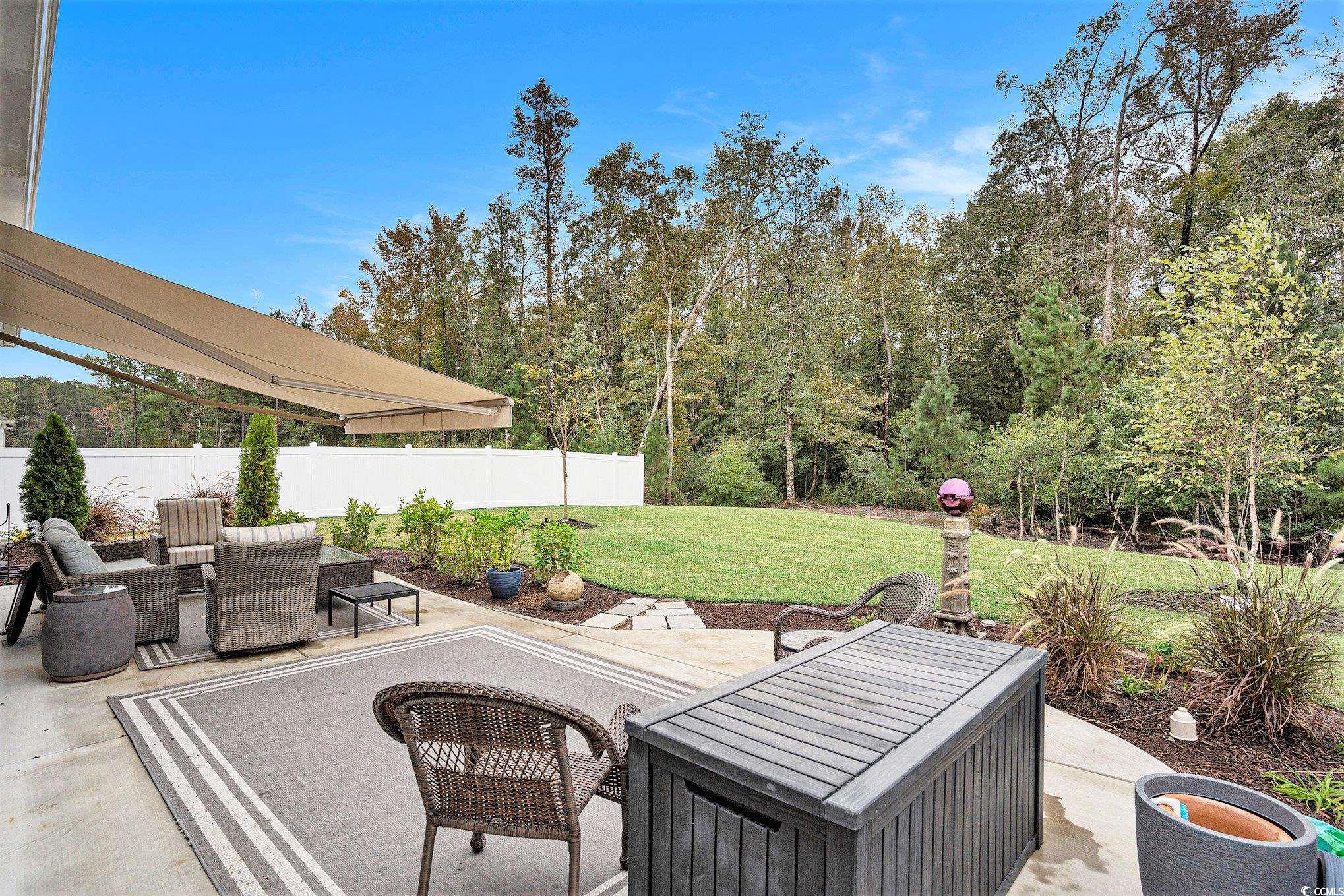 132 Columbus Street Conway, SC 29526 - Photo 32 of 39 View of patio / terrace with a sunroom, an outdoor living space, and view of scattered trees