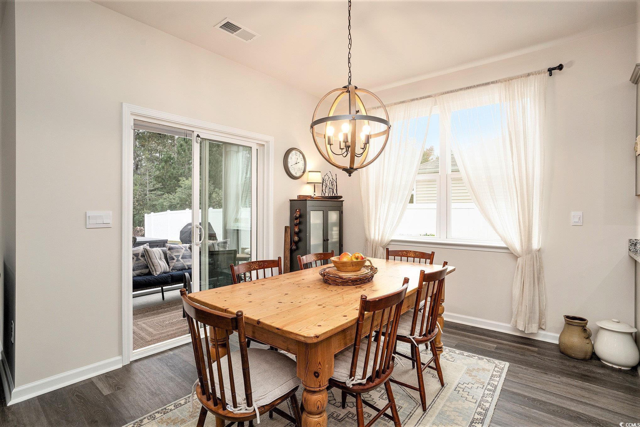 132 Columbus Street Conway, SC 29526 - Photo 10 of 39 Dining space featuring plenty of natural light, dark wood-style floors, and a chandelier