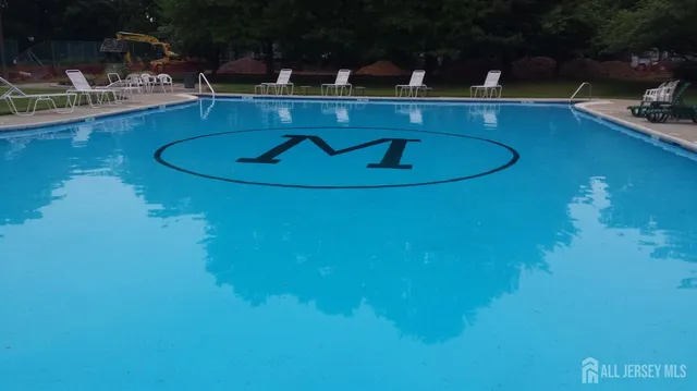 a room with pool table and chairs