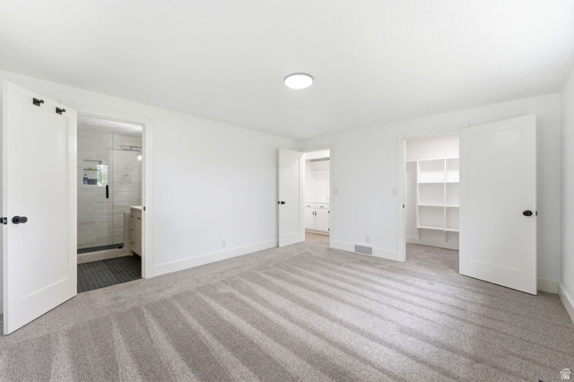871 Bonita Way Centerville, UT 84014 - Photo 15 of 61 Spacious primary bedroom featuring plush gray carpeting, white walls, and a circular flush-mount ceiling light