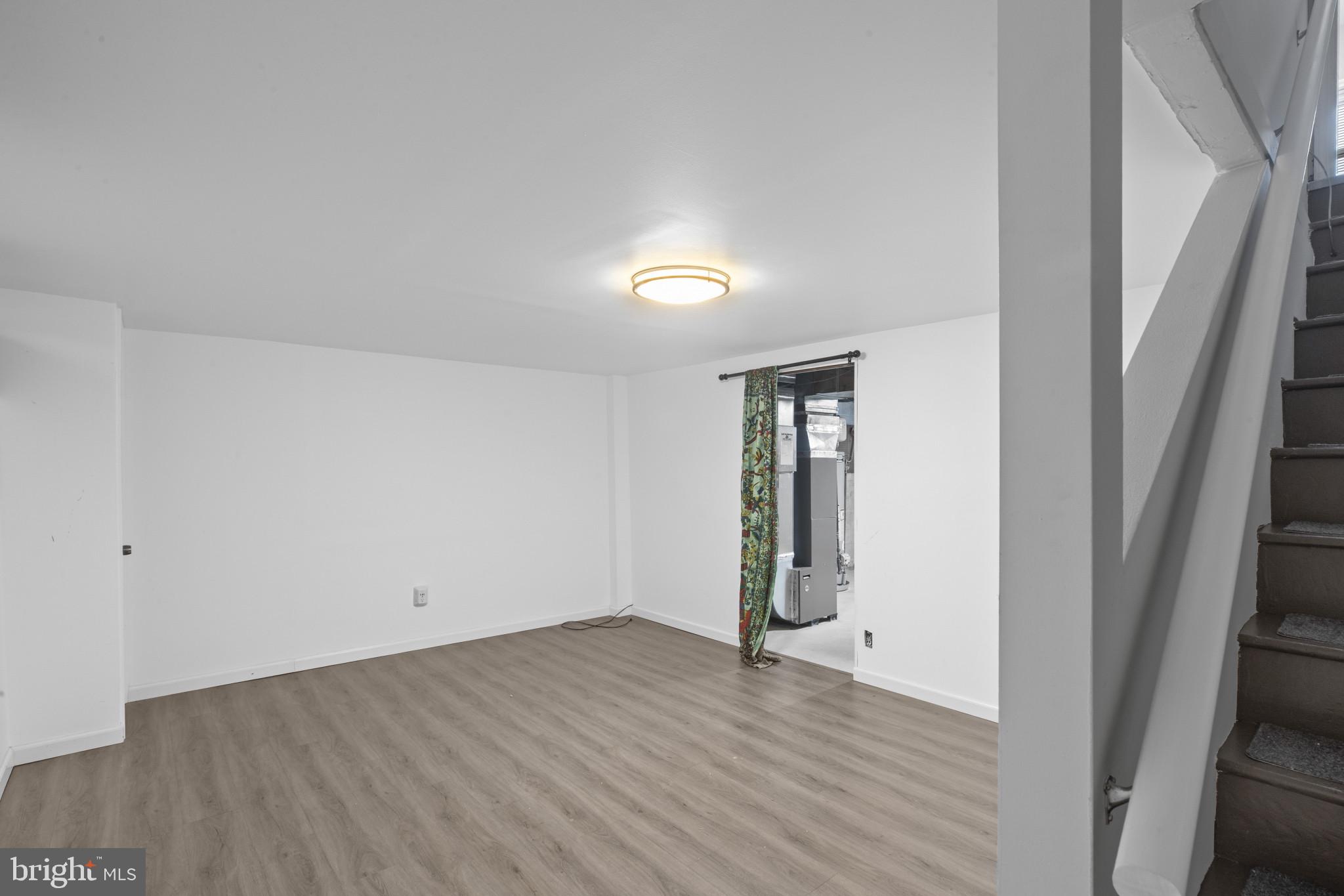 8343 Ridgely Oak Road Parkville, MD 21234 - Photo 14 of 31 an empty room with wooden floor and windows