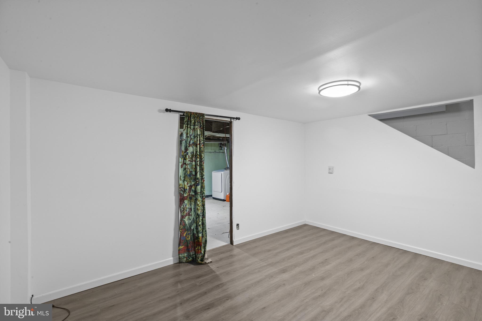 8343 Ridgely Oak Road Parkville, MD 21234 - Photo 15 of 31 a view of an empty room with wooden floor
