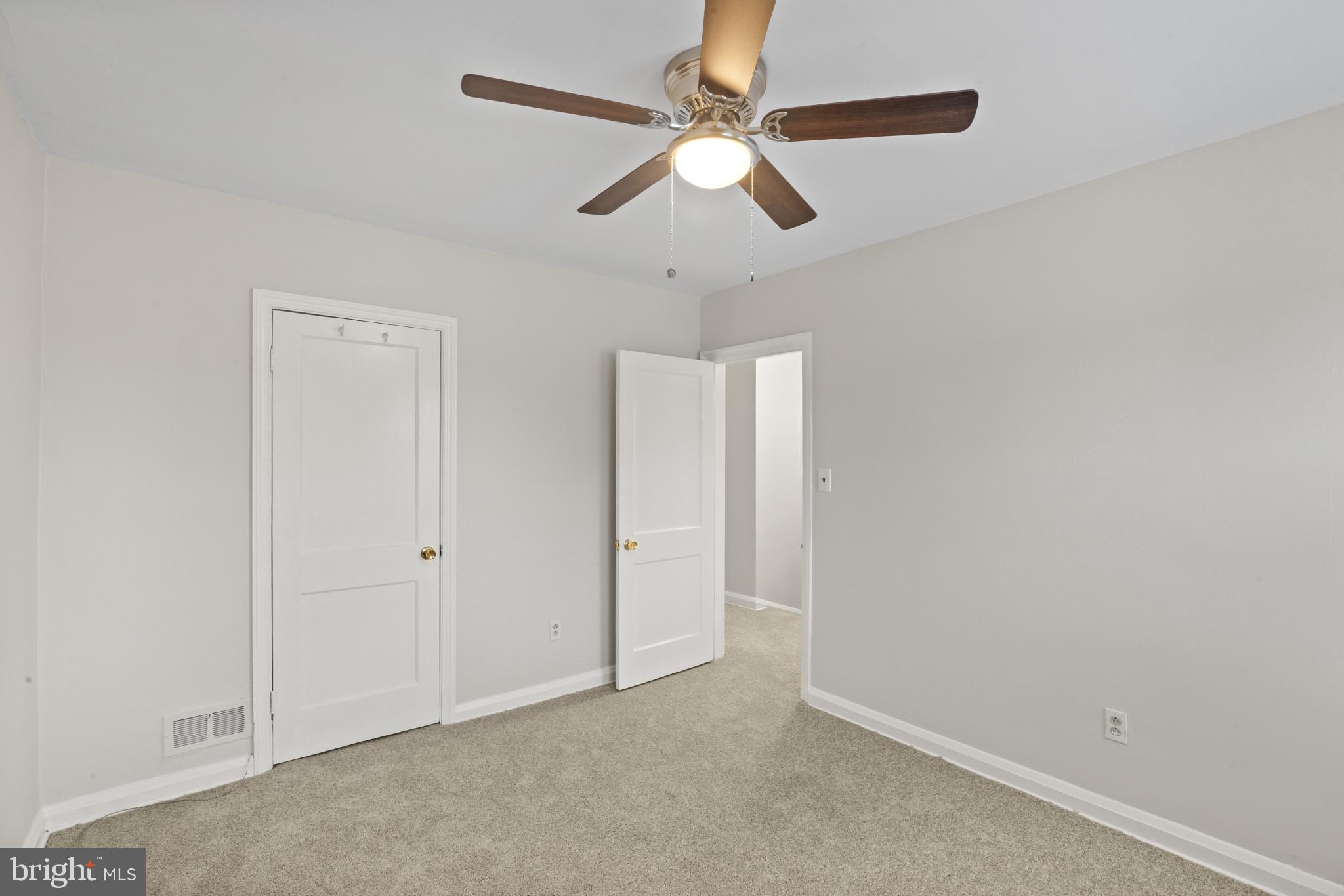 8343 Ridgely Oak Road Parkville, MD 21234 - Photo 18 of 31 an empty room with chandelier fan