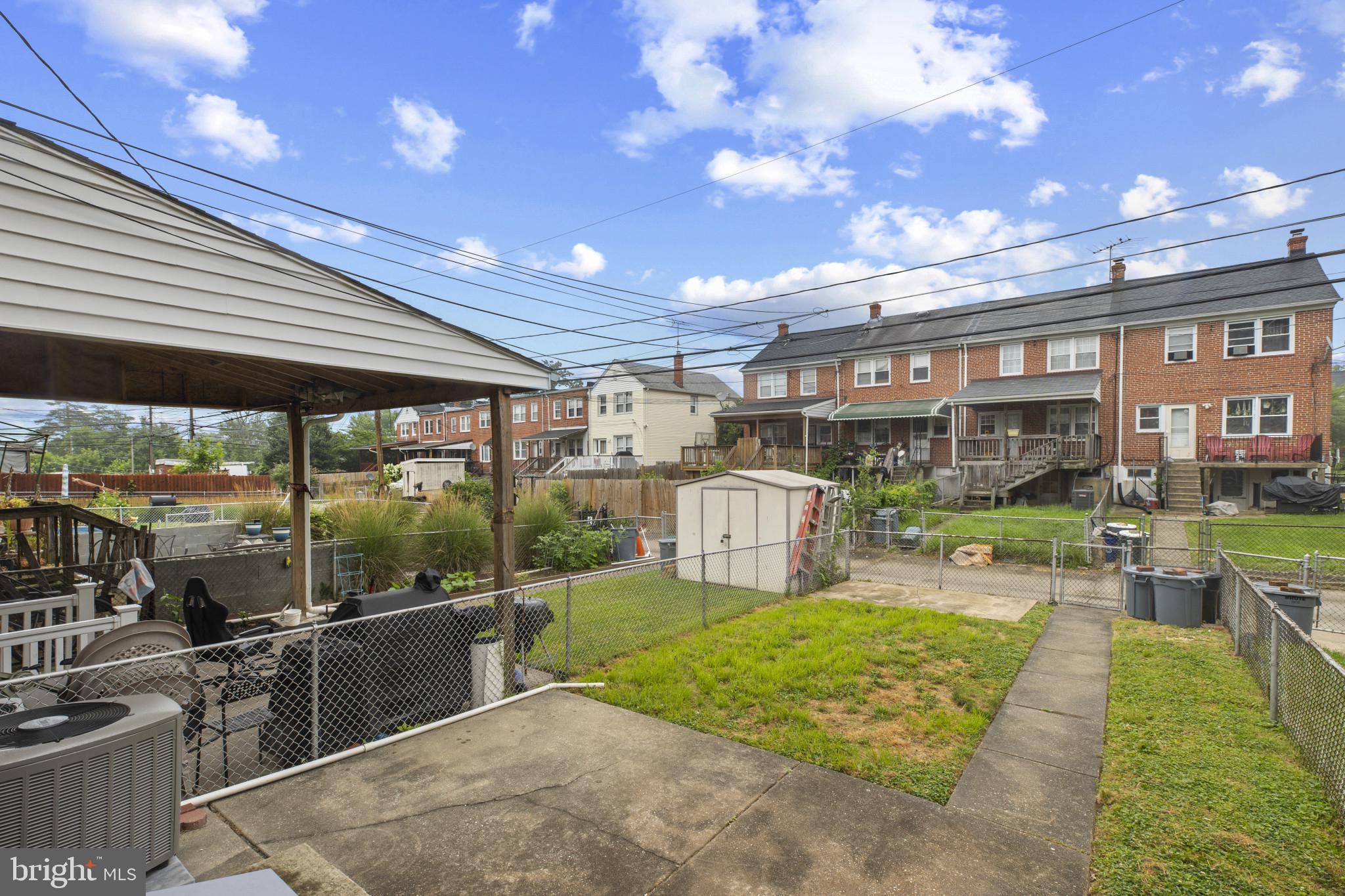 8343 Ridgely Oak Road Parkville, MD 21234 - Photo 25 of 31 a view of a house with backyard porch and sitting area