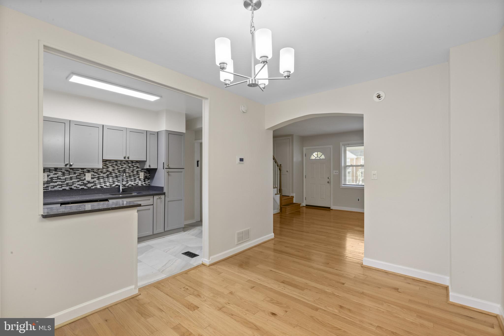 8343 Ridgely Oak Road Parkville, MD 21234 - Photo 8 of 31 a view of a kitchen cabinets and wooden floor