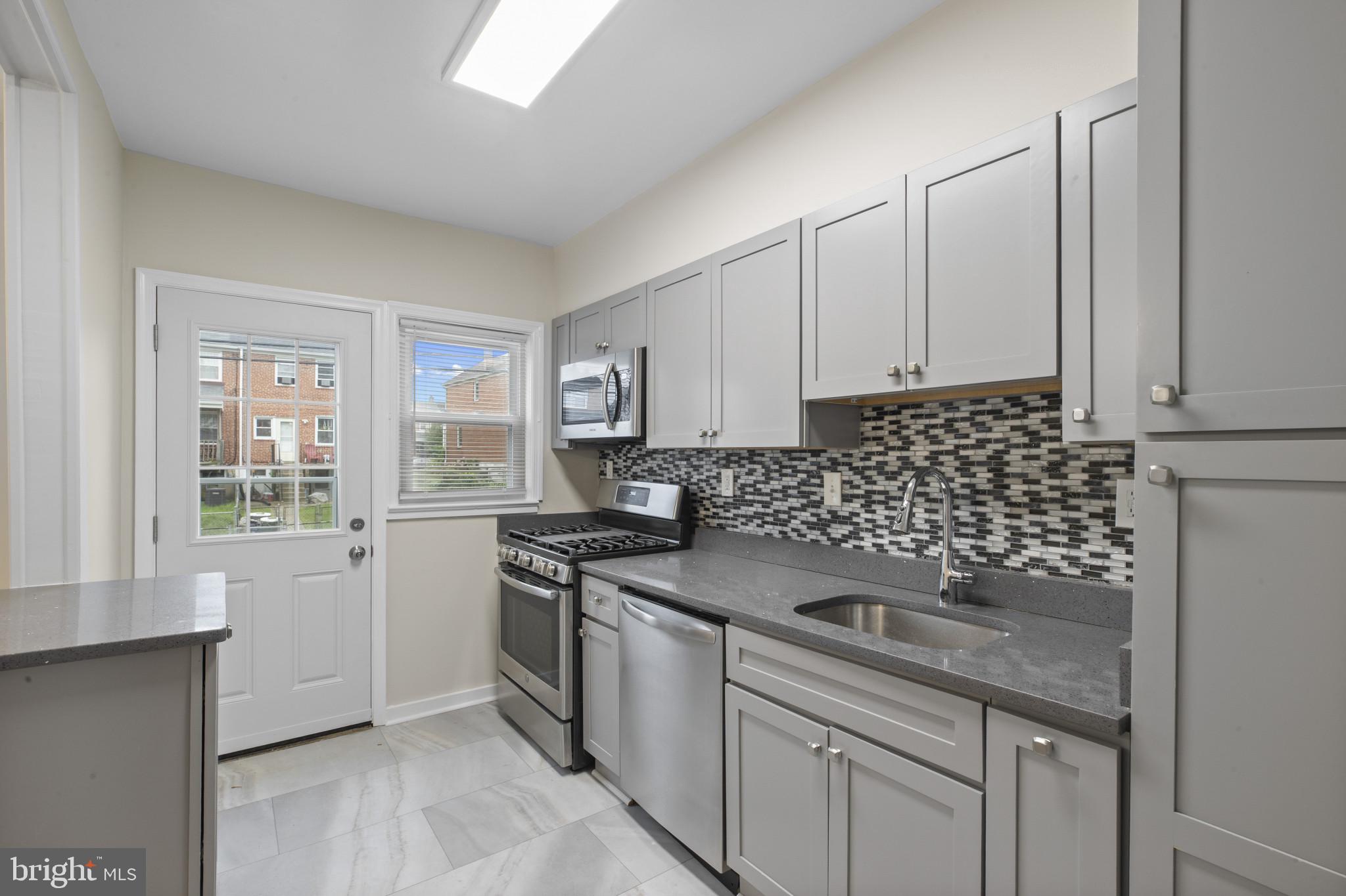8343 Ridgely Oak Road Parkville, MD 21234 - Photo 10 of 31 a kitchen with a sink stove and cabinets