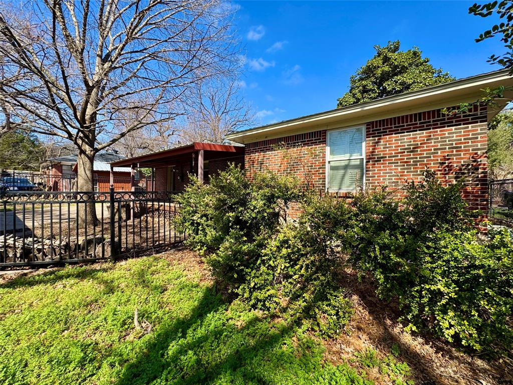 6712 Timothy Drive Dallas, TX 75227 - Photo 14 of 20 View of property exterior with brick siding
