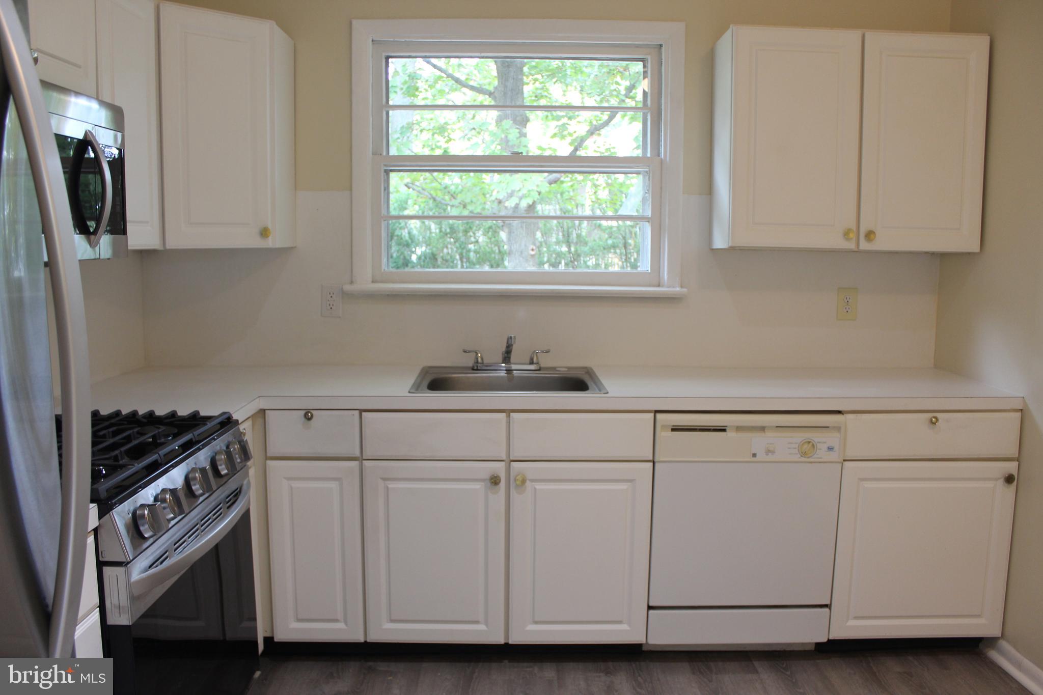 936 North Main Street Glassboro, NJ 08028 - Photo 4 of 12 a kitchen with granite countertop white cabinets and white appliances