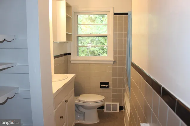 a bathroom with a toilet a sink and a window
