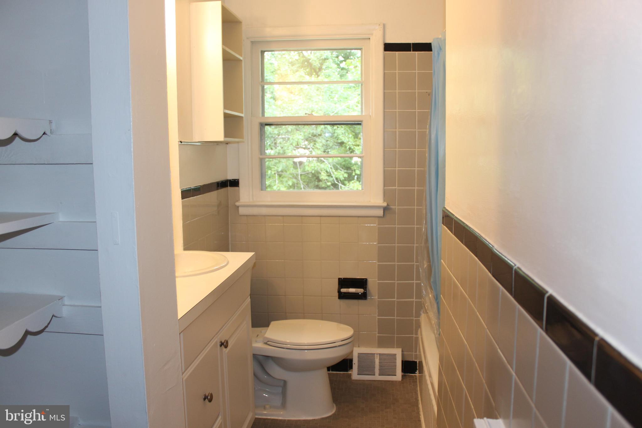 936 North Main Street Glassboro, NJ 08028 - Photo 6 of 12 a bathroom with a toilet a sink and a window
