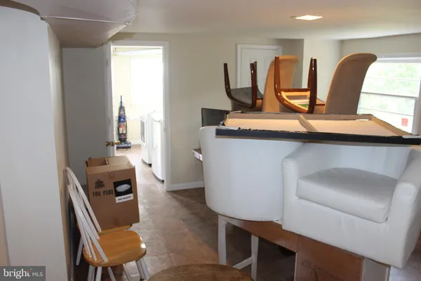 a living room with furniture a sink and a window