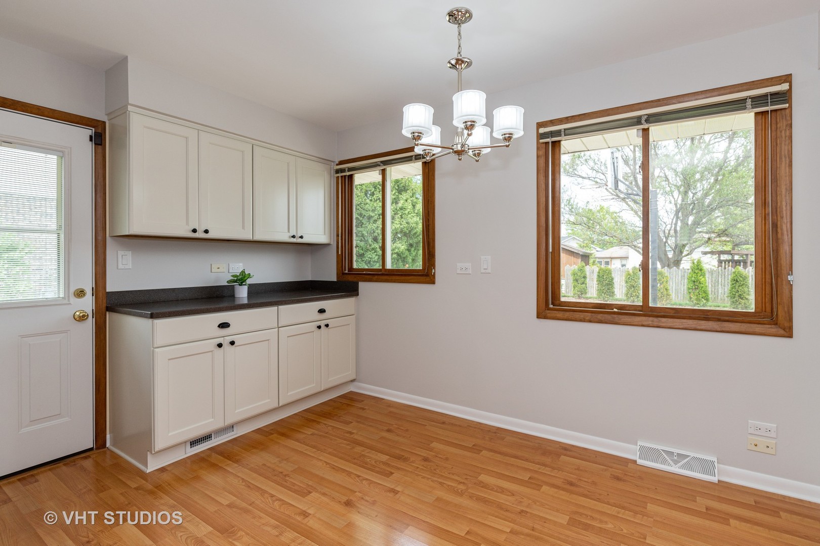 411 Beck Road Lindenhurst, IL 60046 - Photo 4 of 18 a kitchen with stainless steel appliances granite countertop a stove a sink and white cabinets with wooden floor