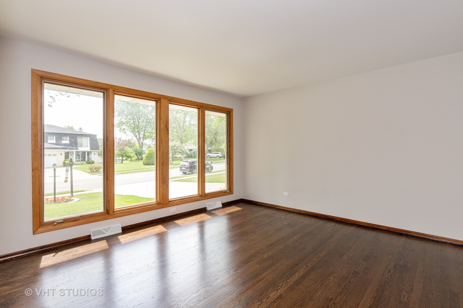 411 Beck Road Lindenhurst, IL 60046 - Photo 5 of 18 a view of an empty room with wooden floor and a window