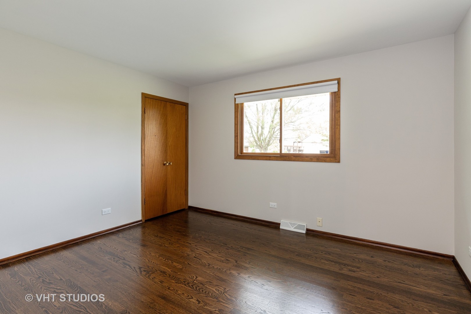 411 Beck Road Lindenhurst, IL 60046 - Photo 10 of 18 a view of an empty room with wooden floor and a window