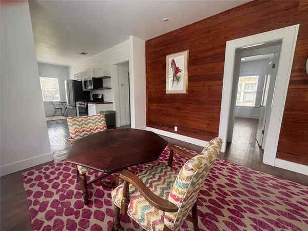 a kitchen with granite countertop a sink stove and refrigerator