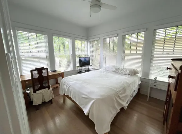 a bedroom with a bed and a window