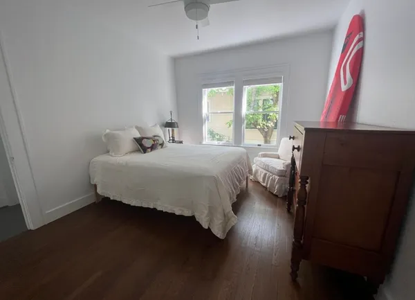 a view of an entryway with wooden floor and a window