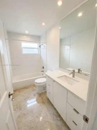 a view of an empty room with a ceiling fan