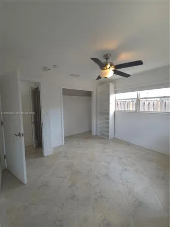 a spacious bedroom with a bed and window