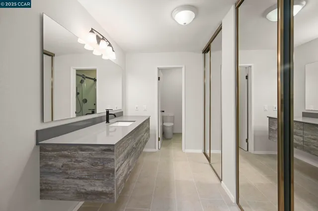 a bathroom with a granite countertop sink mirror and shower