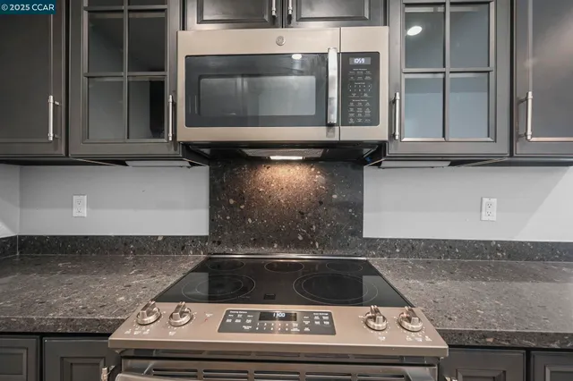 a stove top oven sitting inside of a kitchen