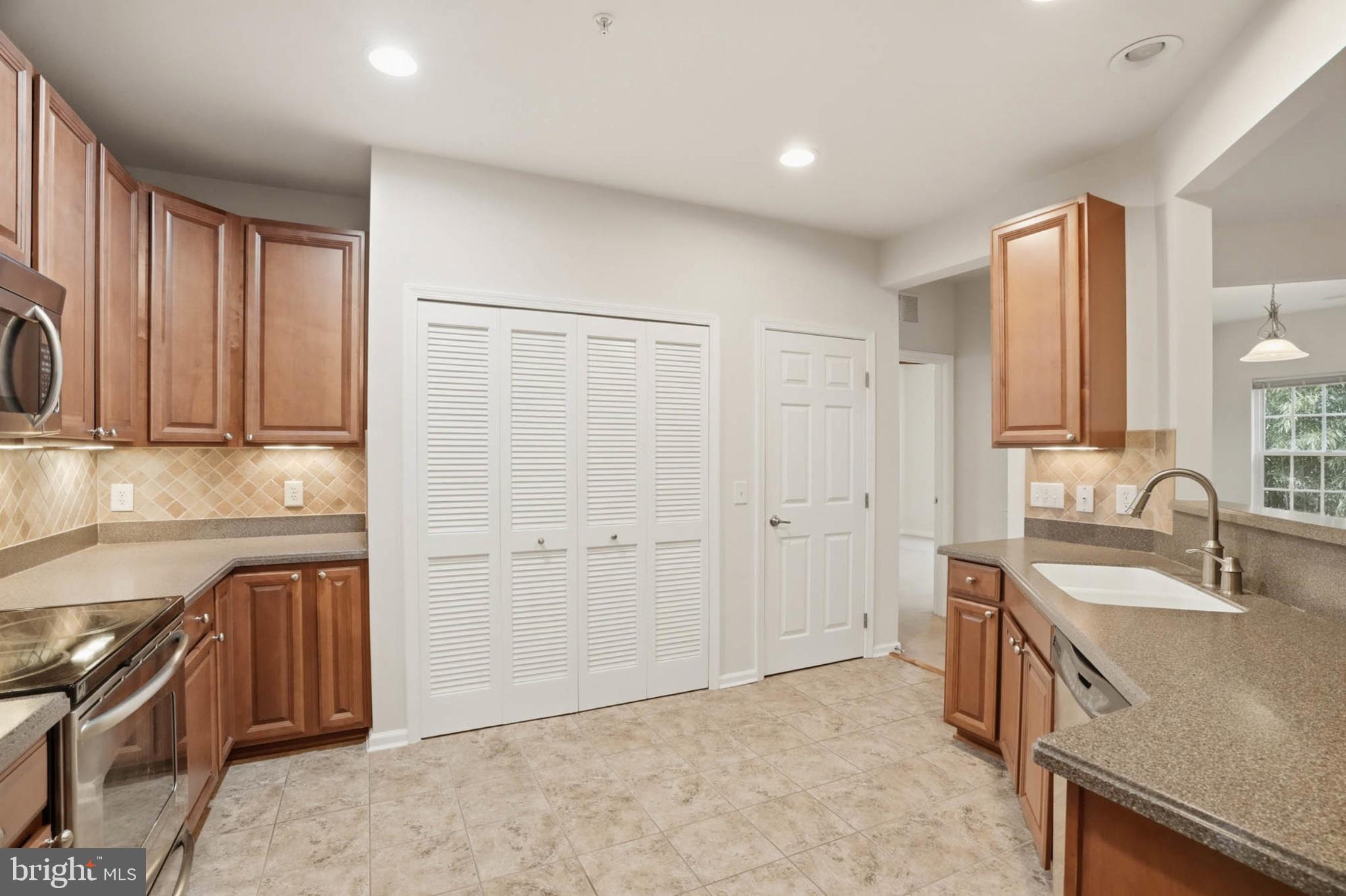 1622 Hardwick Court, Unit 202 Hanover, MD 21076 - Photo 16 of 60 Modern kitchen with warm wood accents.