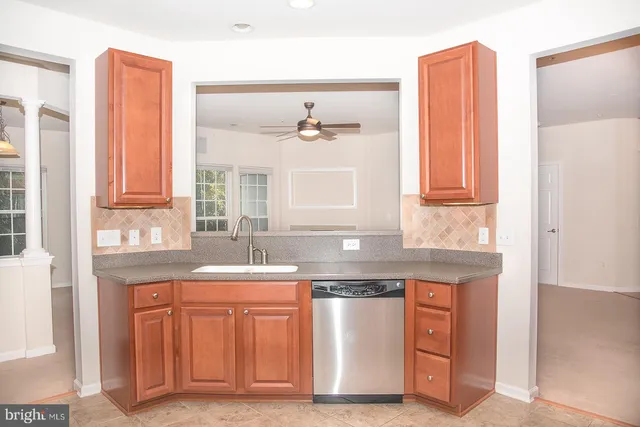a kitchen with stainless steel appliances granite countertop a refrigerator stove top oven