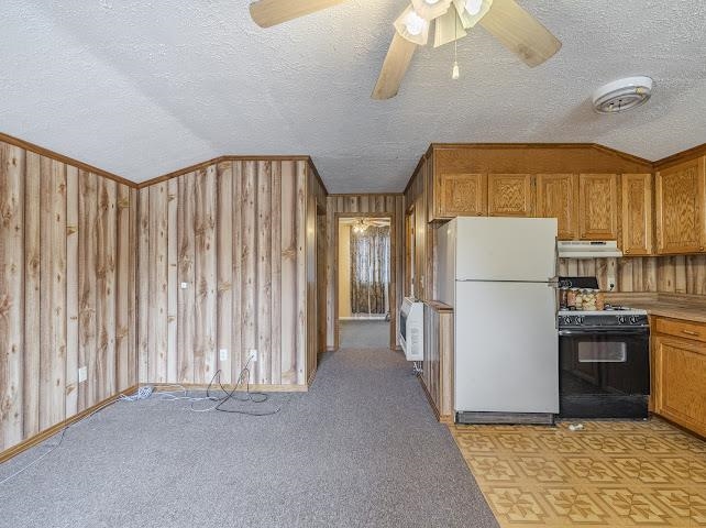 660 Hinton Road Counce, TN 38326 - Photo 34 of 40 Wood-finish wall paneling throughout, complemented by a textured ceiling and a ceiling fan with integrated lighting