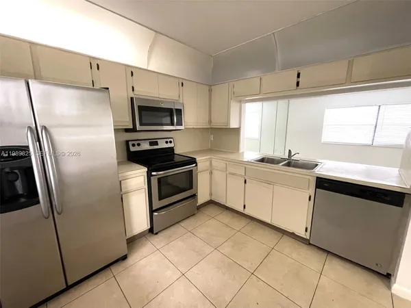 a kitchen with a refrigerator sink and microwave