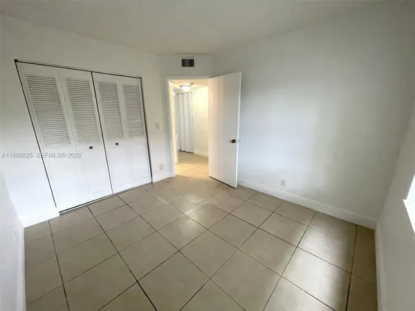 a view of an empty room and entryway