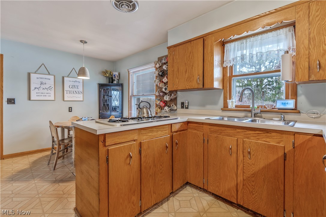 6775 Grove Road Clinton, OH 44216 - Photo 10 of 19 Kitchen with a peninsula, wood finish cabinets, light countertops, and light flooring