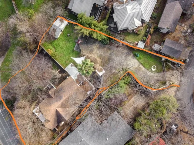 an aerial view of a house with a yard