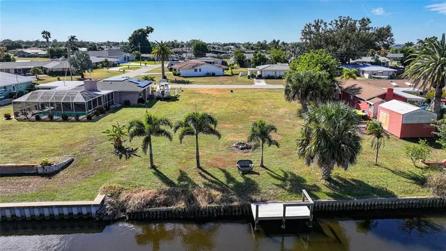 a view of swimming pool with outdoor seating and lake view