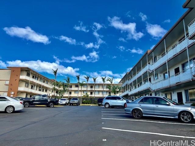 94-054 Leolua Street, Unit C114 Waipahu, HI 96797 - Photo 14 of 18 a car parked in front of a building