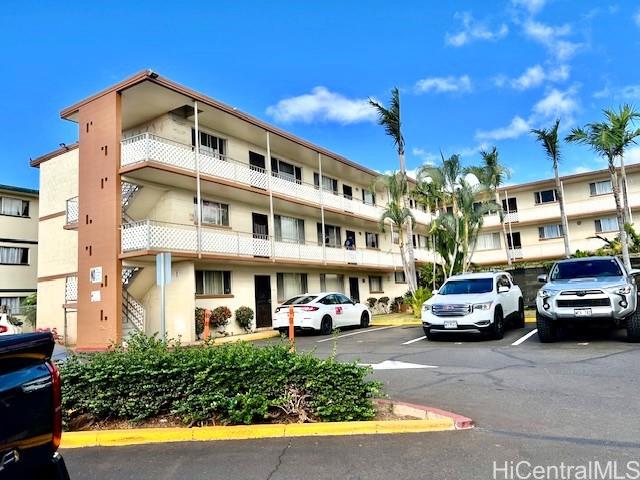 94-054 Leolua Street, Unit C114 Waipahu, HI 96797 - Photo 15 of 18 a view of a cars park in front of a building