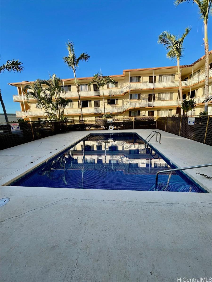 94-054 Leolua Street, Unit C114 Waipahu, HI 96797 - Photo 16 of 18 a view of a balcony with two couches and a potted plant