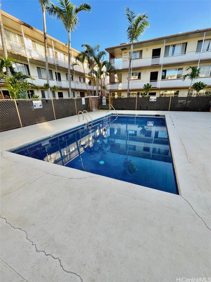 94-054 Leolua Street, Unit C114 Waipahu, HI 96797 - Photo 18 of 18 a view of a swimming pool with outdoor seating