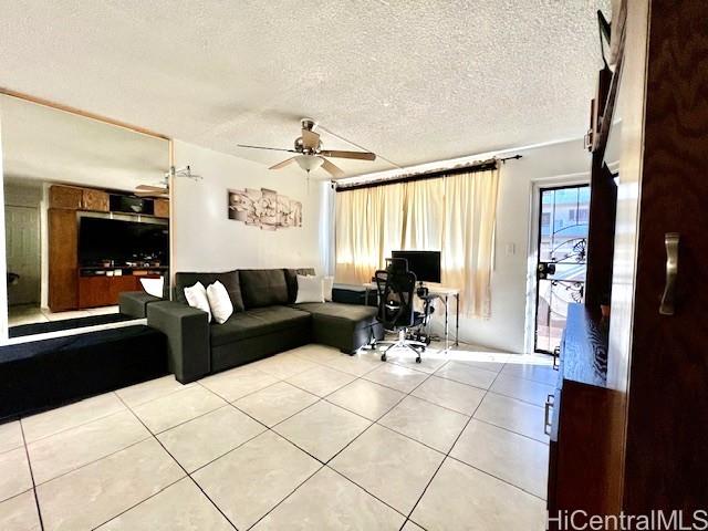 94-054 Leolua Street, Unit C114 Waipahu, HI 96797 - Photo 2 of 18 a living room with furniture and a flat screen tv