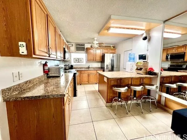 a kitchen with stainless steel appliances kitchen island granite countertop a sink and cabinets