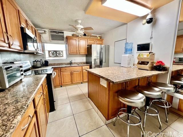 94-054 Leolua Street, Unit C114 Waipahu, HI 96797 - Photo 5 of 18 a large kitchen with a table and chairs in it