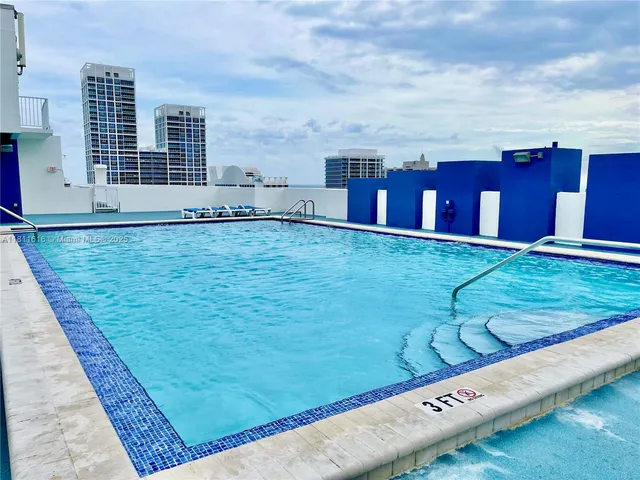 a view of a big yard with an ocean view