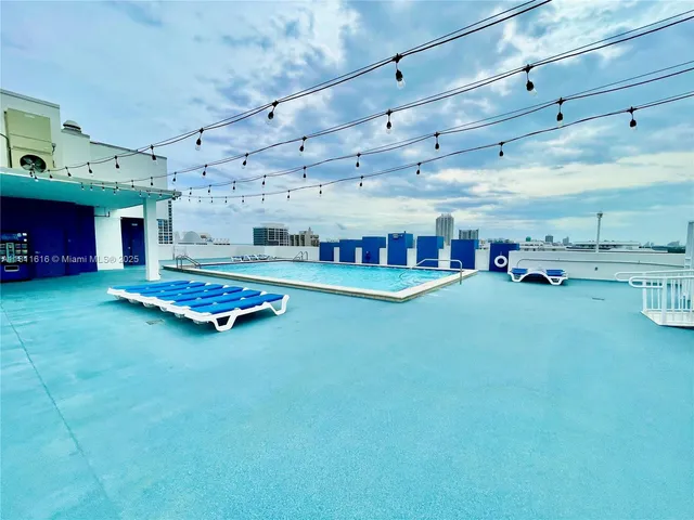 a living room with lots of furniture and kitchen view