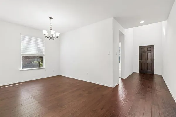 a view of livingroom with hardwood floor and kitchen view