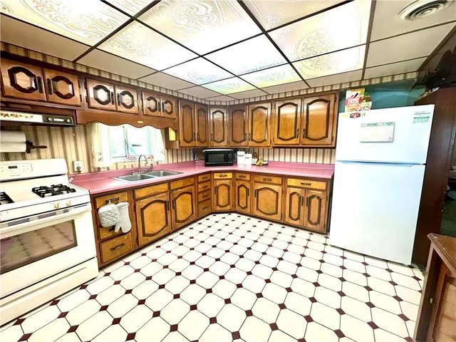 a kitchen with a stove a sink and a refrigerator